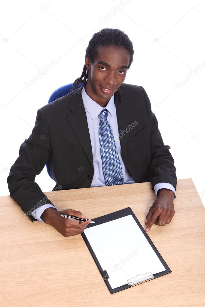 Young African American businessman at office desk