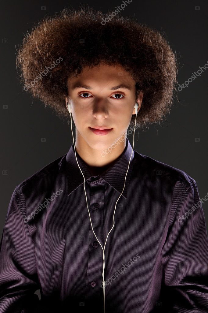 Young man wears music ear plugs and big afro hair Stock Photo by  ©darrinahenry 7091406