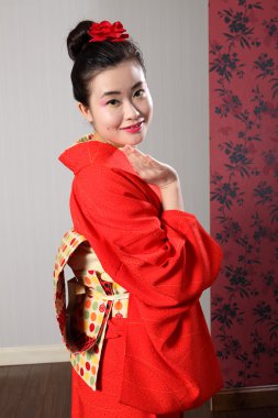 Greeting by Asian woman in Japanese kimono robe