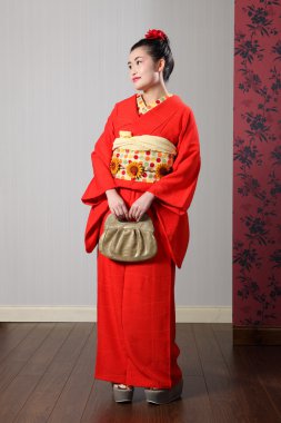 Beautiful oriental woman in red japanese kimono clipart