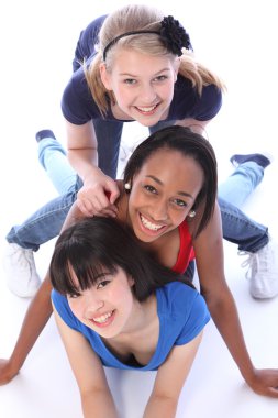 Three mixed race girl friends having fun together clipart