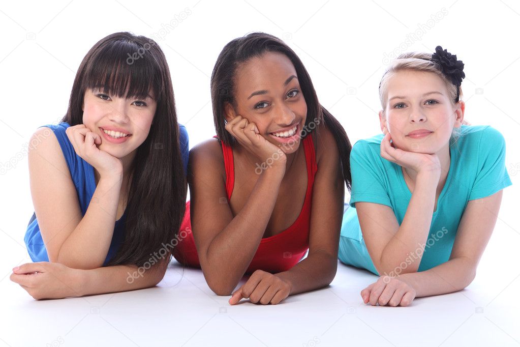 Black white and asian girl friends lying on floor