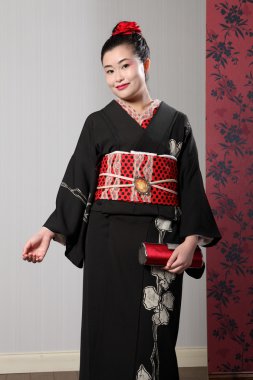 Smile from Asian woman in black japanese kimono clipart