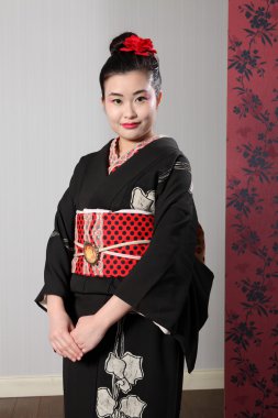 Oriental woman in black japanese kimono robe dress clipart
