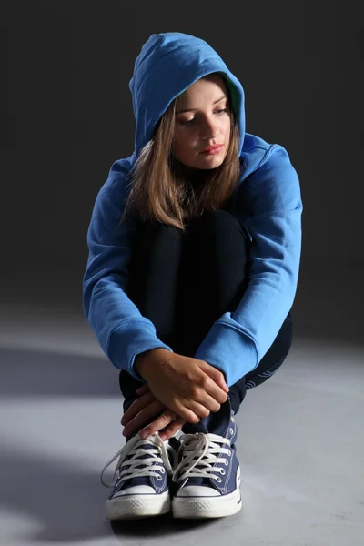 Loira adolescente menina sozinha e triste de capuz azul — Fotografia de Stock