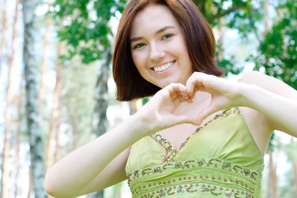 Girl with a heart sign — Stock Photo, Image