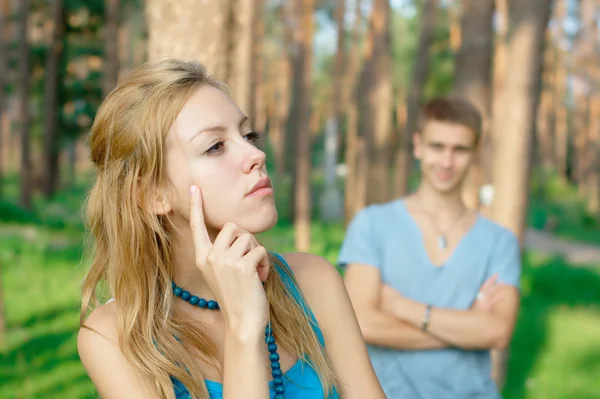Offended girl and a boy at the background — Stock Photo, Image