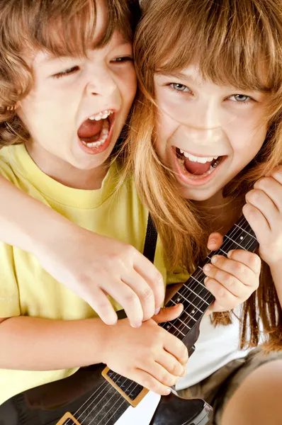 Kids playing guitar singing Royalty Free Stock Images
