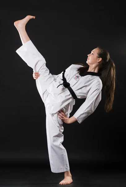 Girl in kimono exercising karate kata — Stock Photo, Image