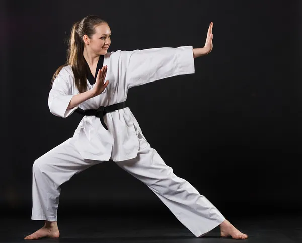 Stock image Girl in kimono exercising karate kata