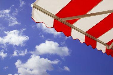 Awning over bright sunny blue sky clipart