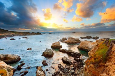 Big Sur Pacific Ocean coast at sunset clipart