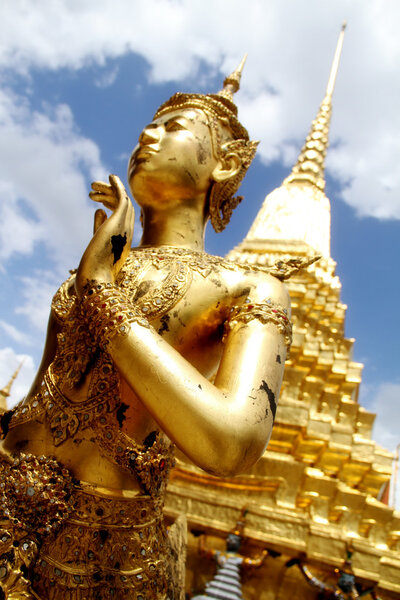 Golden Kinnari statue at The Grand Palace in Bangkok, Thailand