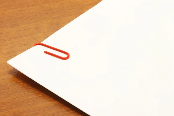 Piece of paper with a red clip on the table — Stock Photo, Image