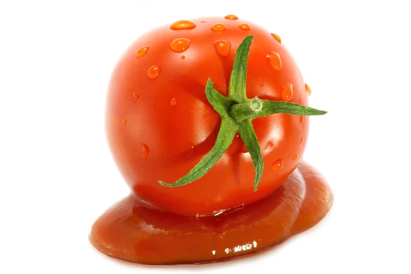 Red tomato in sauce — Stock Photo, Image