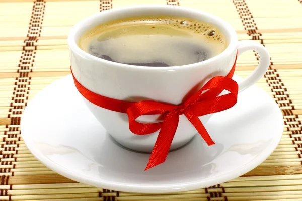 Coffee cup with red bow — Stock Photo, Image