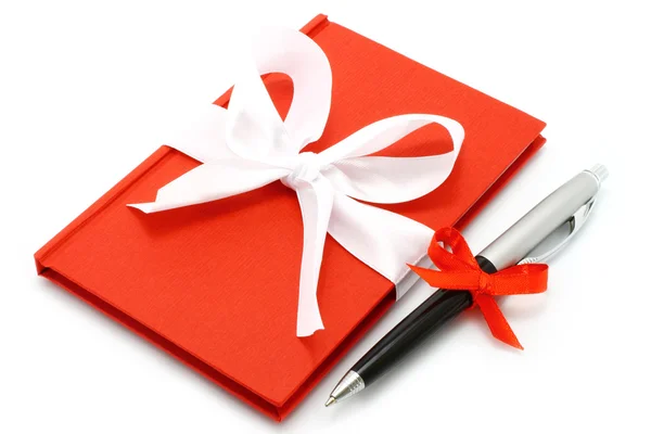 Notepad with white bow and pen — Stock Photo, Image