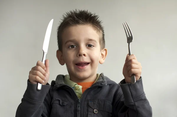 Criança com faca e garfo — Fotografia de Stock
