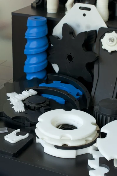 Plastic machine parts. Vertical imagel — Stock Photo, Image