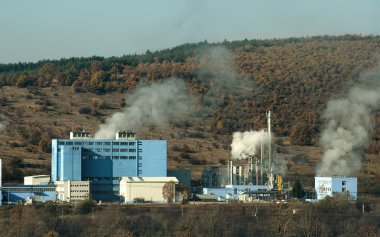 Industrial factory with chimneys and smoke clipart