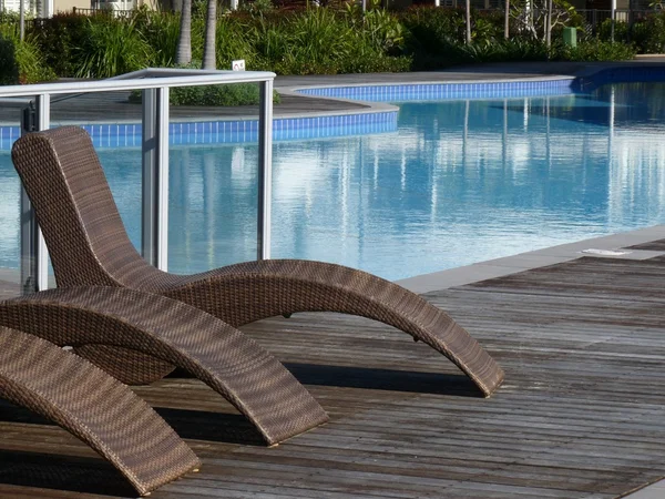 Deckchairs by the pool — Stock Photo, Image