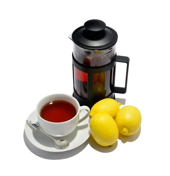 stock image Cup of tea, kettle and three lemons isolated on white