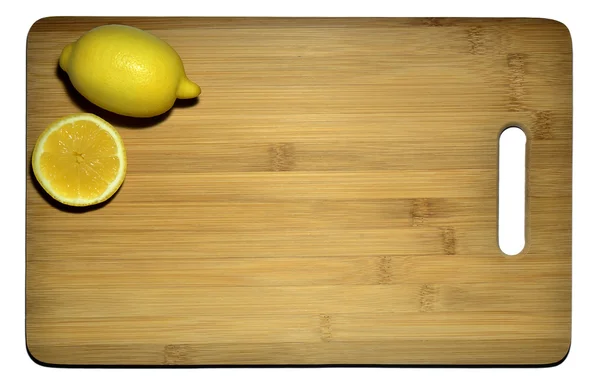 Kitchen board with two lemons isolated on white, space for text — Stock Photo, Image