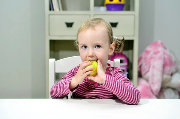 Kis lány étkezési zöld alma — Stock Fotó
