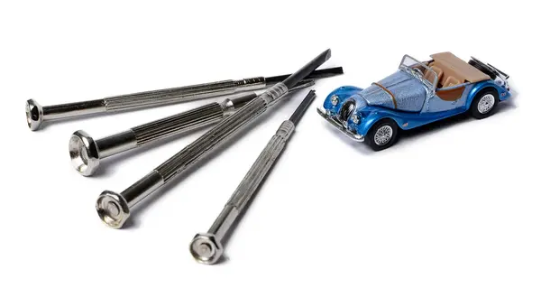 Miniature car and a screwdrivers isolated on white Stock Photo