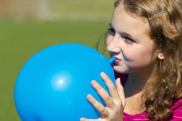 stock image Teen girl inflates the balloon