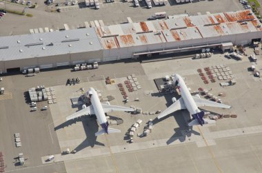 FedEx Airliners Unloading at Busy Airport clipart