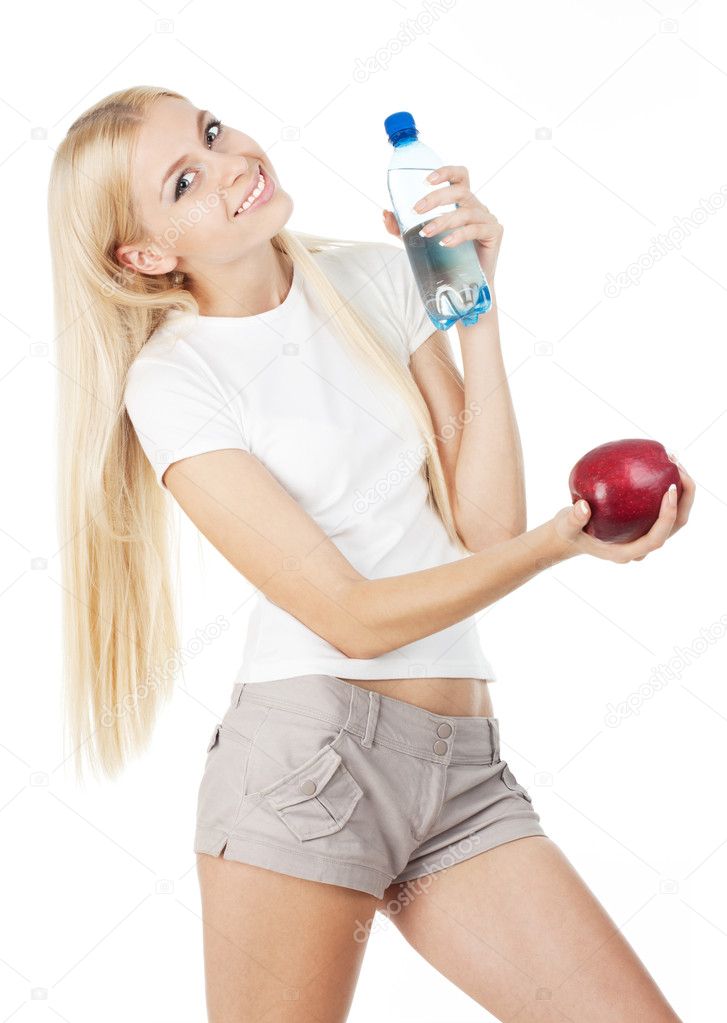 Happy fitnesswoman with a bottle of water and red apple