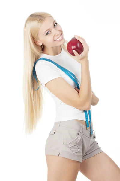 Joven mujer deportiva con cinta métrica y manzana roja —  Fotos de Stock