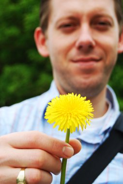 Young man offering a flower clipart