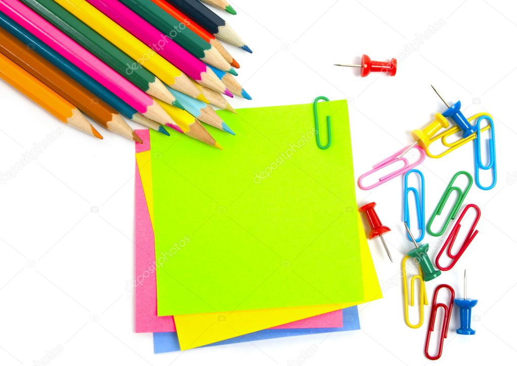 Colored pencil, clips and note paper on white