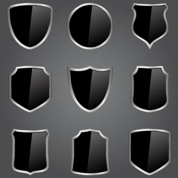 Escudos negros vectoriales — Vector de stock