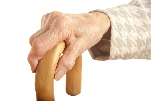 Old Ladies hand with walking stick — Stockfoto