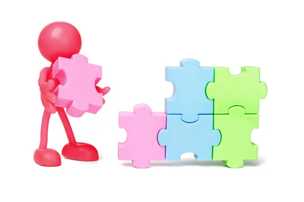 Faceless figurine and jigsaw puzzles — Stock Photo, Image