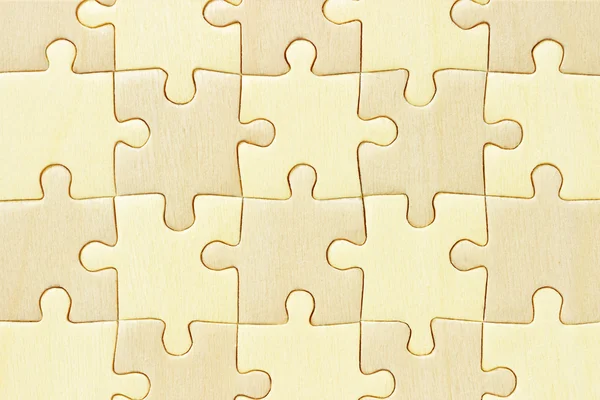 Checkered wooden jigsaw puzzle background — Stockfoto