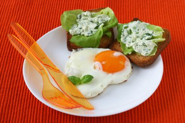 Fried egg with toasts with cream-cheese clipart