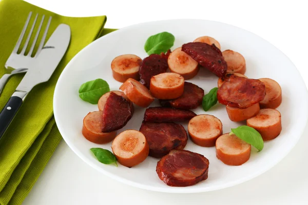 Cut fried sausages on a plate — Stock Photo, Image