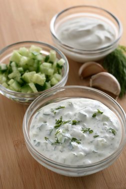 Cucumber dip in small bowl clipart