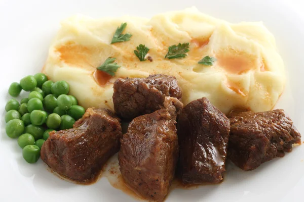 Fried beef with mashed potato and peas — Stock Photo, Image