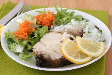 Boiled fish with salad and sauce clipart