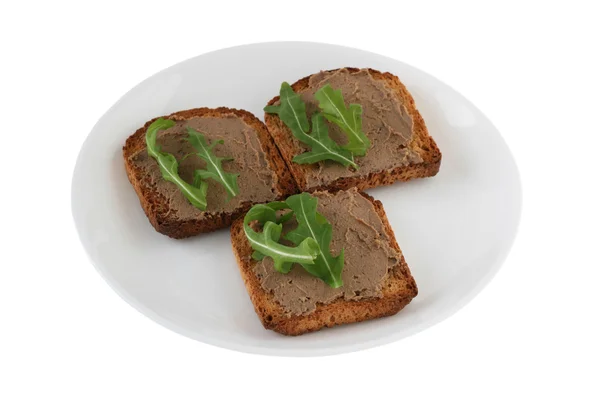 Toasts with pate and rucola on an white plate — Stock Photo, Image
