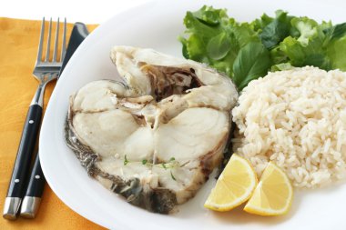 Boiled fish with rice and lemon