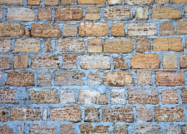 Parede construída de tijolos de pedra, fundo textural — Fotografia de Stock