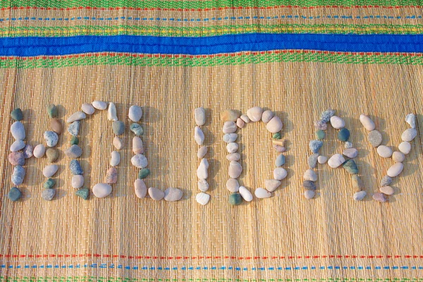 Holiday word made of pebbles — Stock Photo, Image