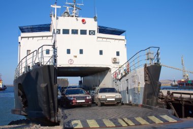 Ferryboat with cars in harbor. train ferry between port Crimea, Kerch, Ukraine and port Caucasus, Russia clipart