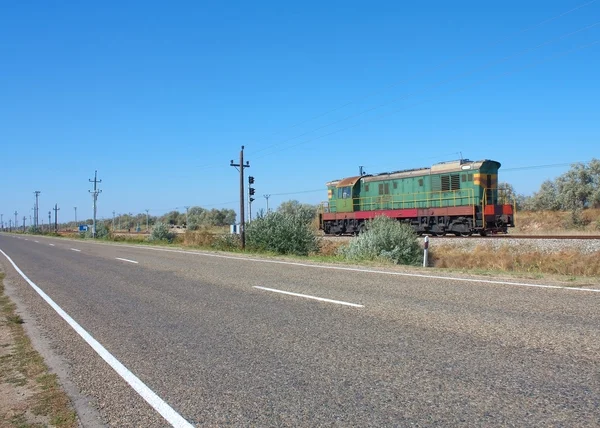 Old diesel locomotive moving along the road — Stock Photo, Image